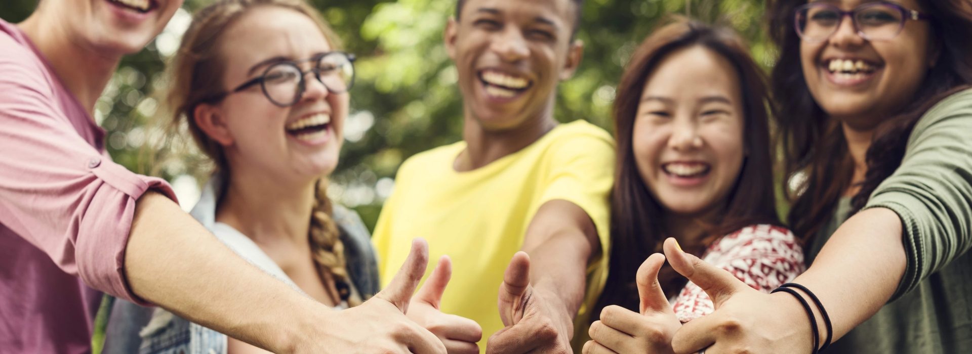 teenagers giving a thumbs up to the camera