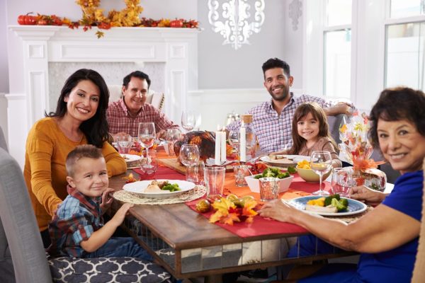 Smiling family eating Thanksgiving dinner